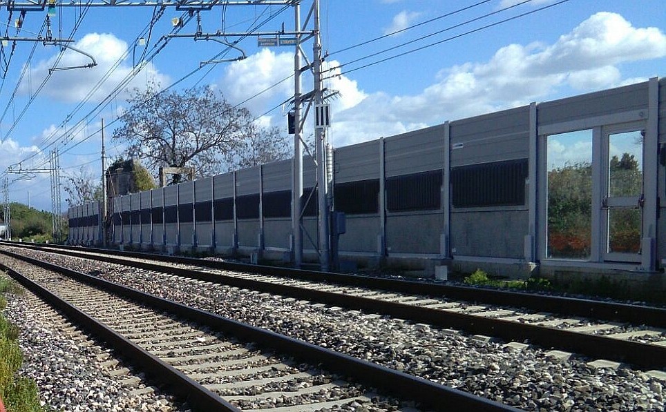 Vista interna da lato ferrovia con porta di emergenza - Barriera antirumore ferroviaria realizzata con pannelli fonoassorbenti in calcestruzzo e acciaio inox